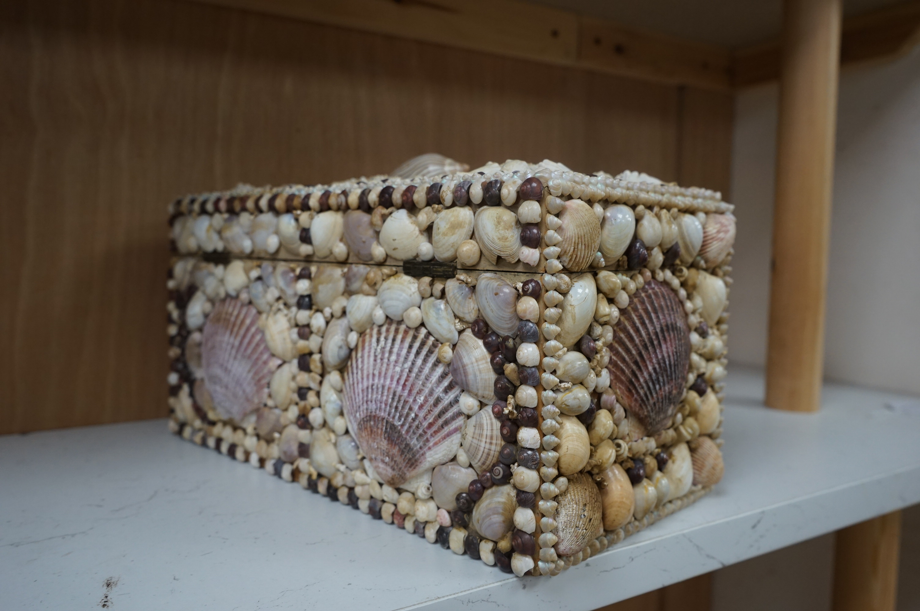 A George III tea caddy, shell covered in 19th century. 32cm wide x 15cm high x 17cm deep. Condition - a few shells missing but appears in good condition